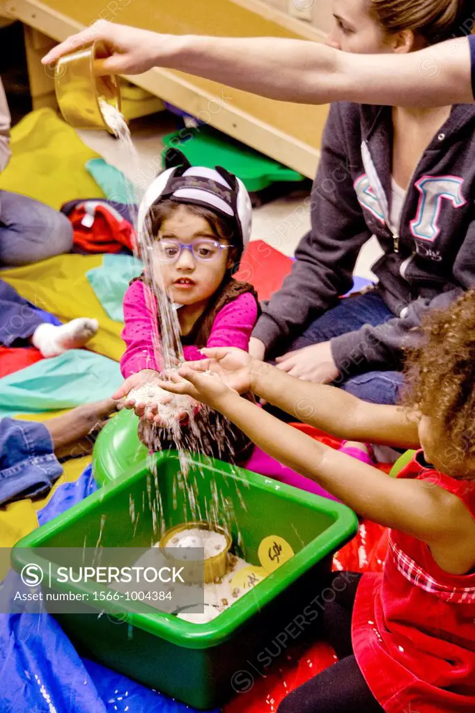 Blind and vision-impaired children sift sand to improve their tactile perception in a sensory motor group at the Blind Children´s Learning Center in S...