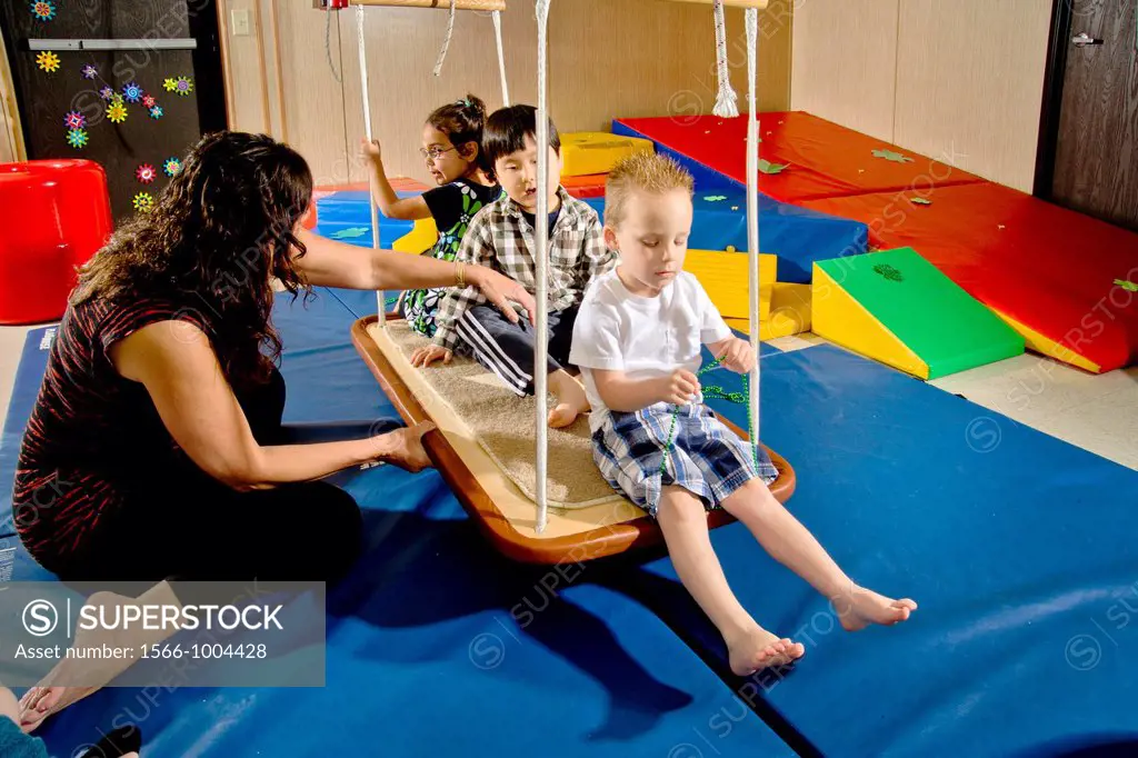 Blind and vision-impaired children ride a swing to improve their balance and body awareness in a sensory motor group at the Blind Children´s Learning ...