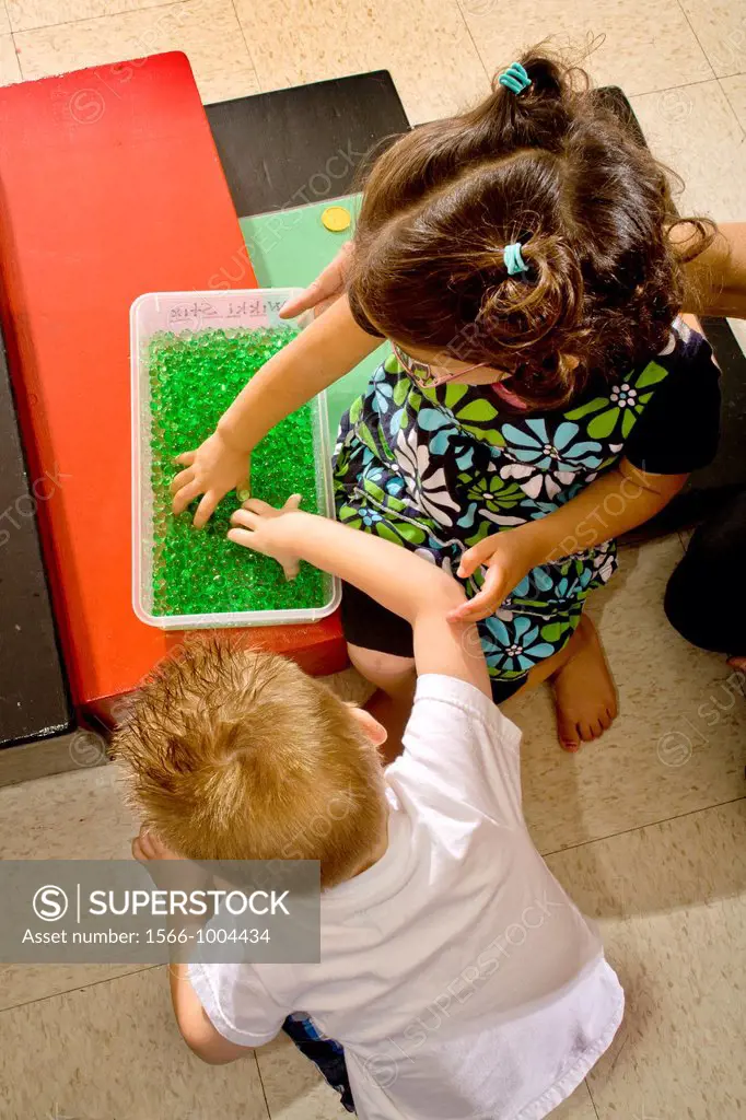Blind children children feel green gel marbles to improve their tactile sensitivity in a sensory motor group at the Blind Children´s Learning Center i...