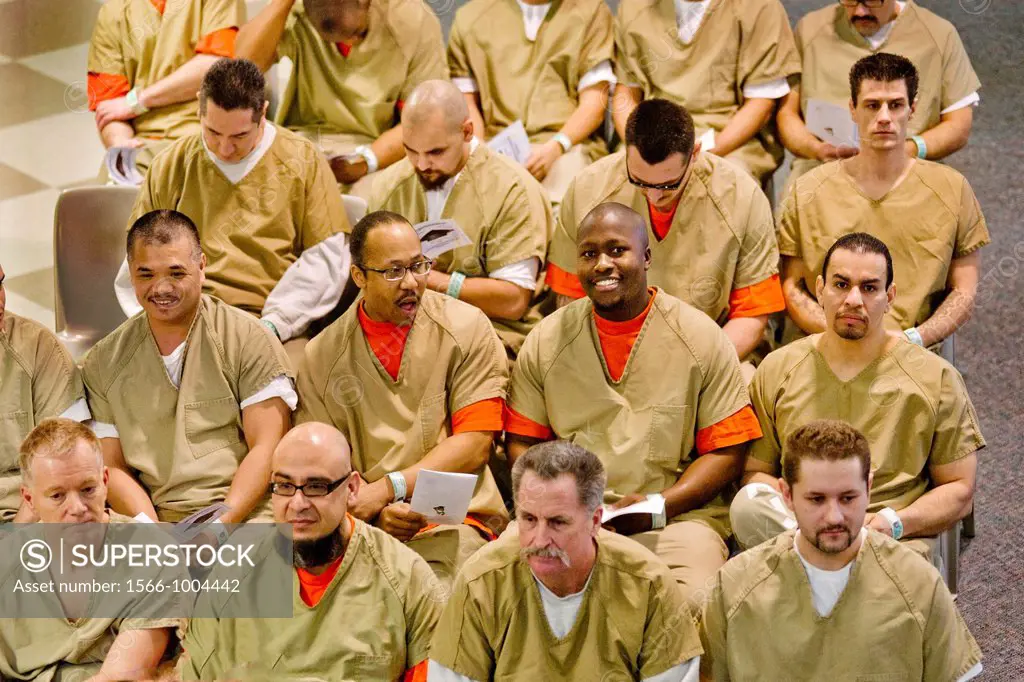 Uniformed multiracial male inmates of the city jail in Santa Ana, CA, gather for a ceremony