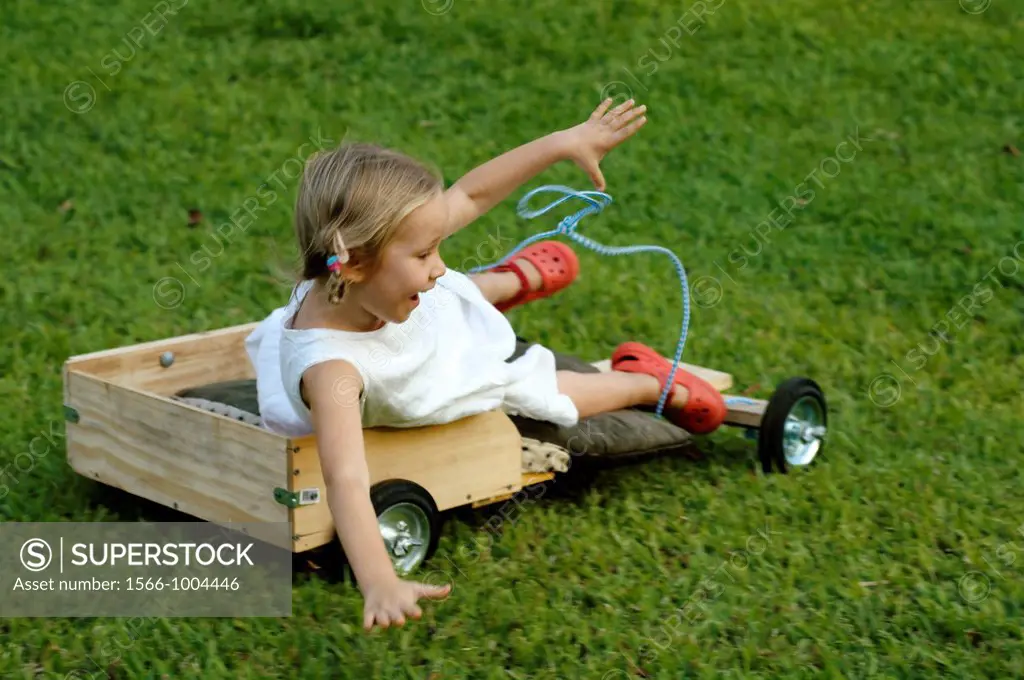 A 4 year old girl falling from her wooden kart