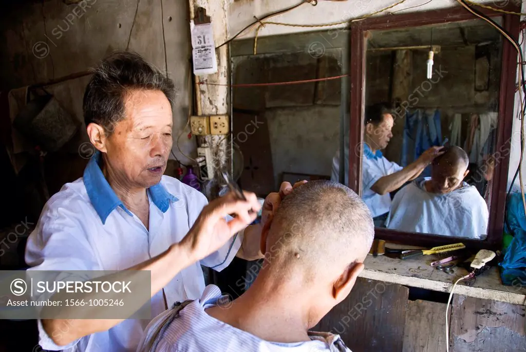Scene in a Barber shop in the ancient village of Langzhong, Sichuan Province, China.