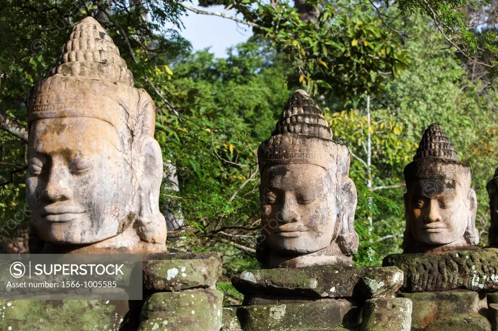 Stone sculptures border the bridge to the temple Angkor Thom in Angkor Cambodia Asia