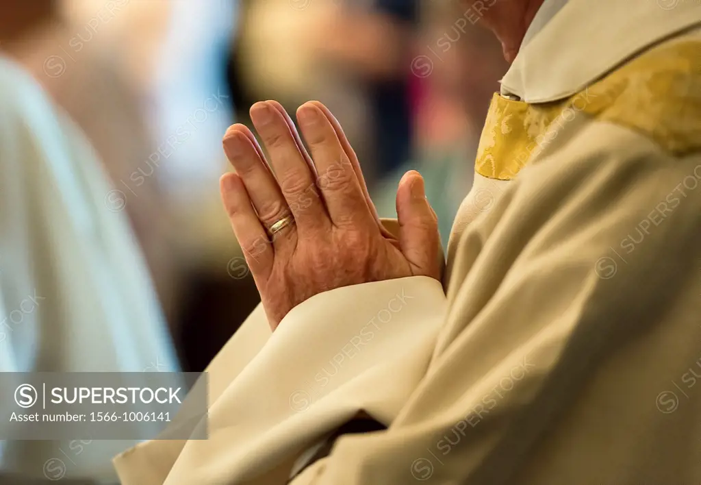 Praying hands of a priest