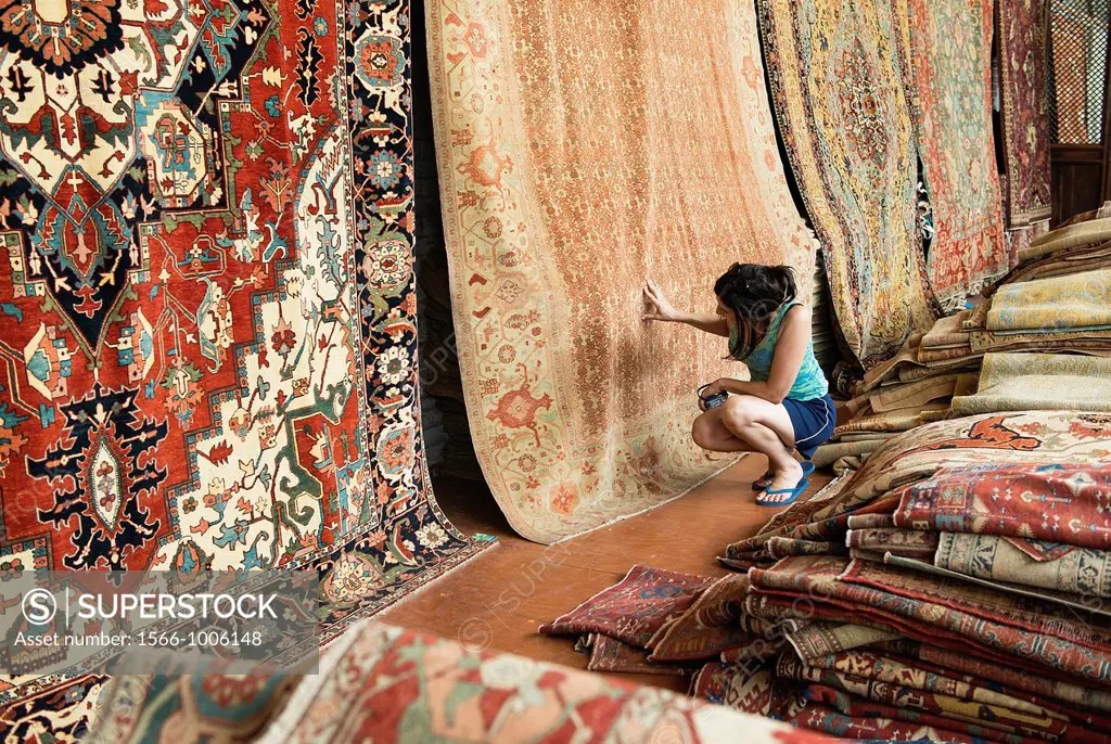 Woman shopping for an oriental carpet, Philadelphia, USA
