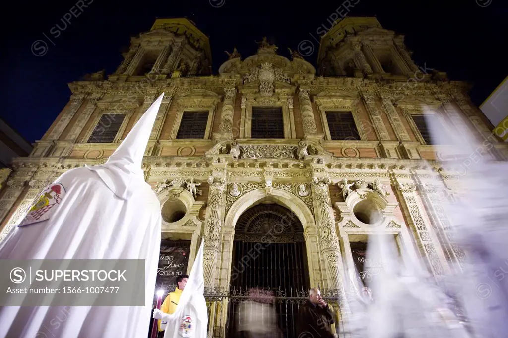 Hooded penitents in front of San Luis church, Holy Week, Seville, Spain