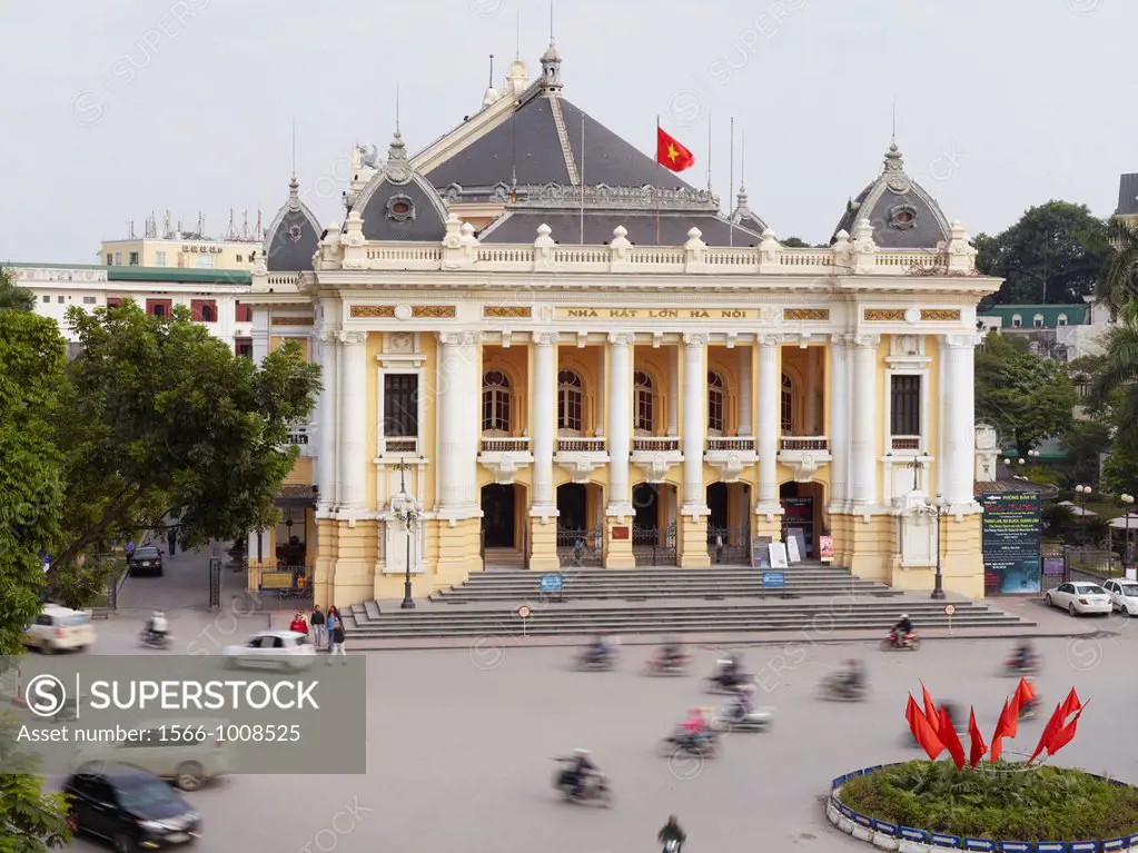 Traffic buzzing by the Hanoi Opera House, a colonial era structure erected by the French