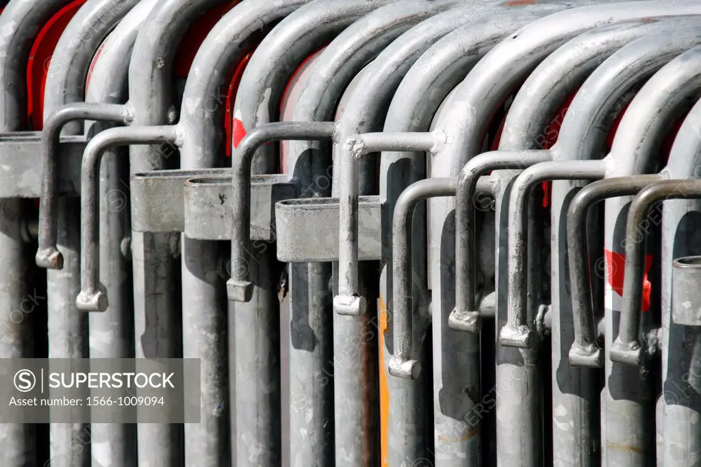 rows of many metal crowd control barriers gates