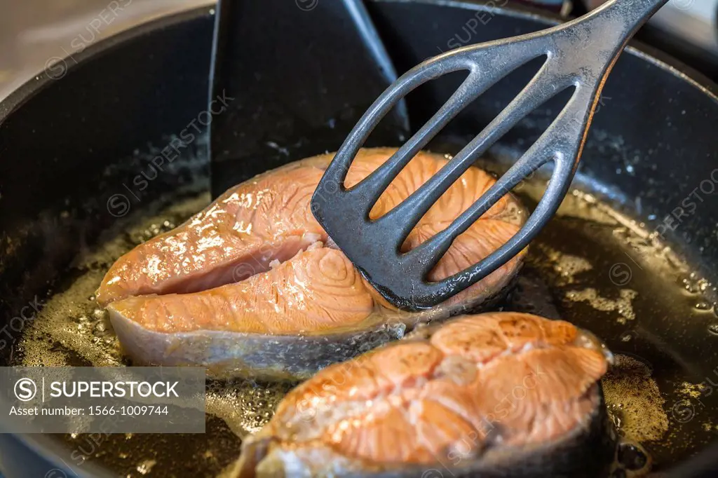 Frying salmon in a frying pan