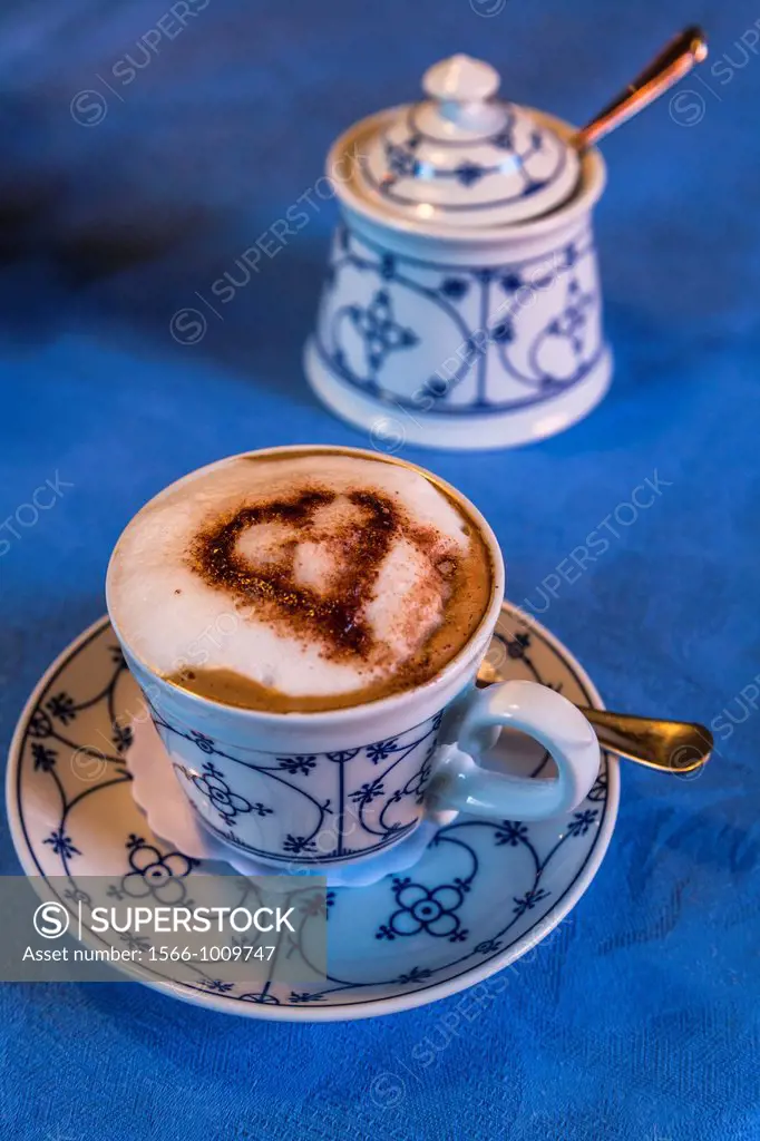 Close up of a cup of cappuccino and a sugar bowl