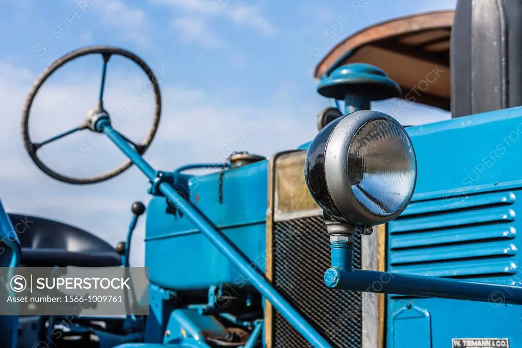 Detail of a steering wheel and headlight of a vintage tractor, Germany, Europe