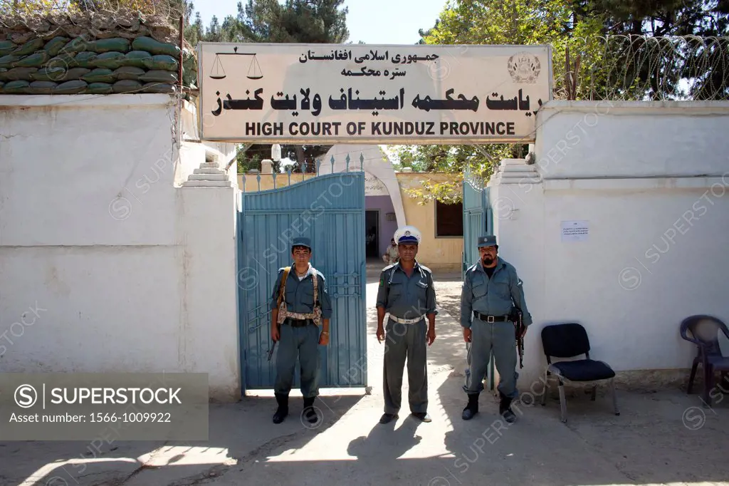 Afghan police secures the entrance of the high court in Kunduz