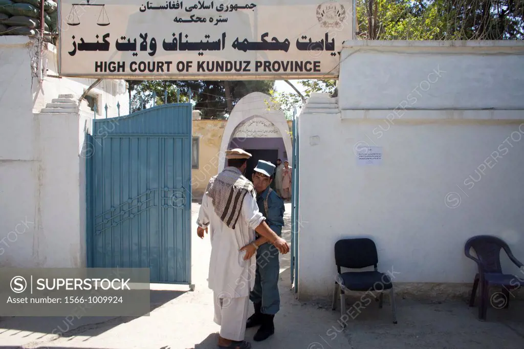 Afghan police secures the entrance of the high court in Kunduz