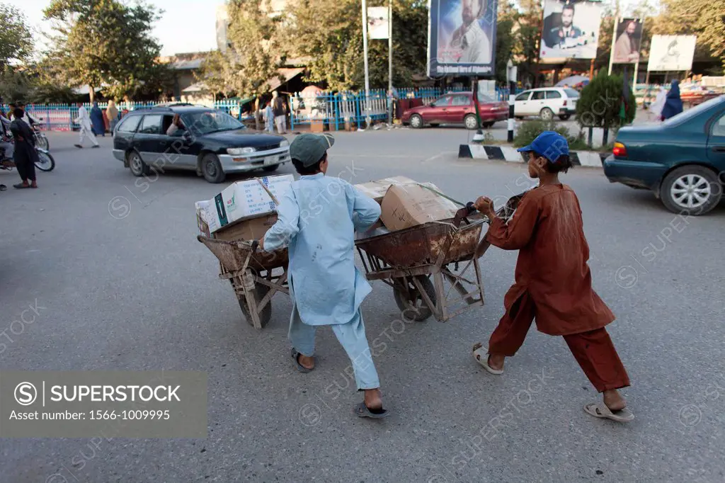 afghan kids work as porter