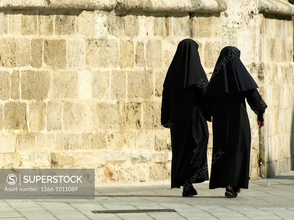 nuns walking along a wall in the cathedral of Palencia Castilla