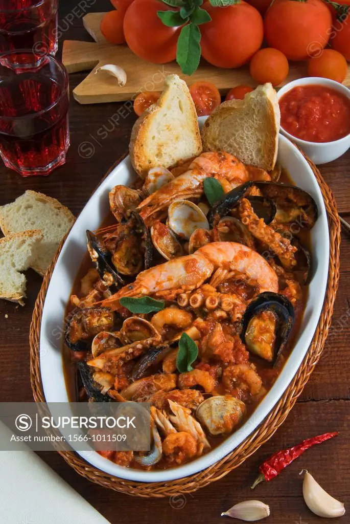 Cacciucco, it is an Italian fish stew consisting of several different types of fish and shellfish cooked in wine, tomatoes, and chili pepper  Livorno ...
