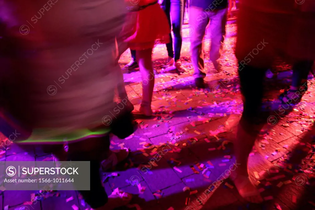 crowd on dance floor in night club disco