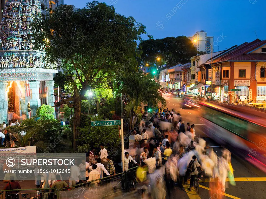 People walking along the roads in Little India at night with an Indian temple on the left  Little India in Singapore, a focal gathering point for Indi...