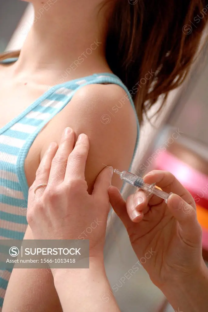 Young woman having an injection in her upper arm