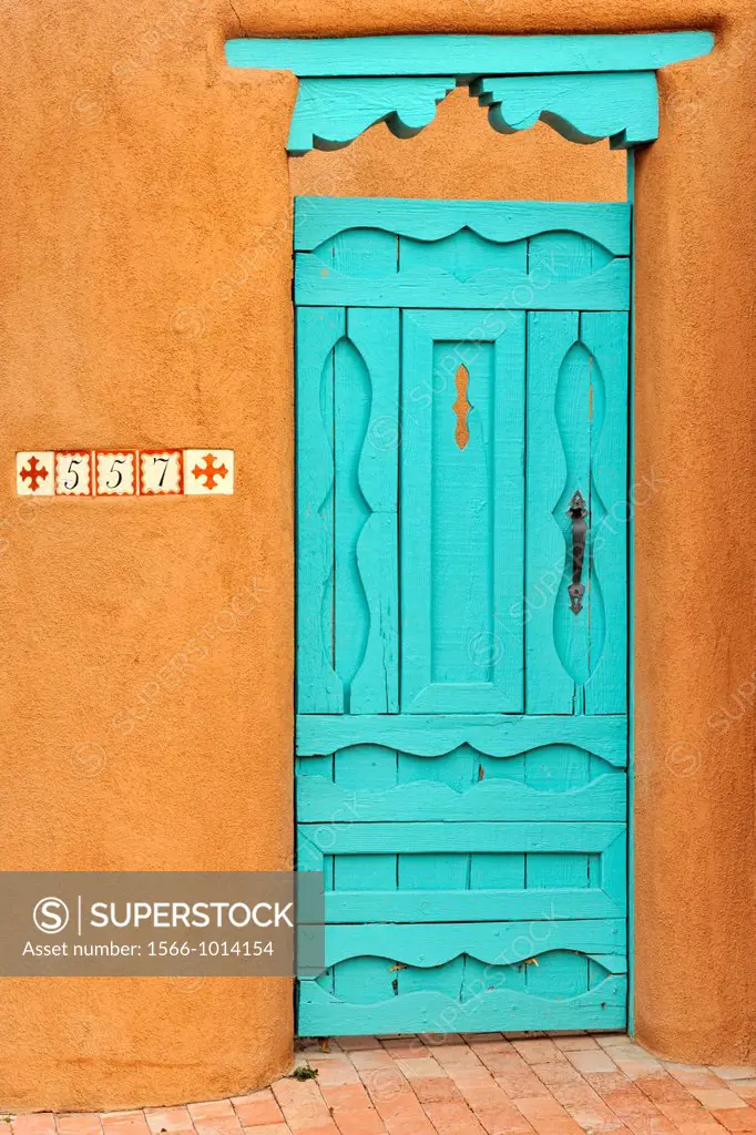 Adobe wall details, with painted door in residential Santa Fe, Santa Fe, New Mexico, USA