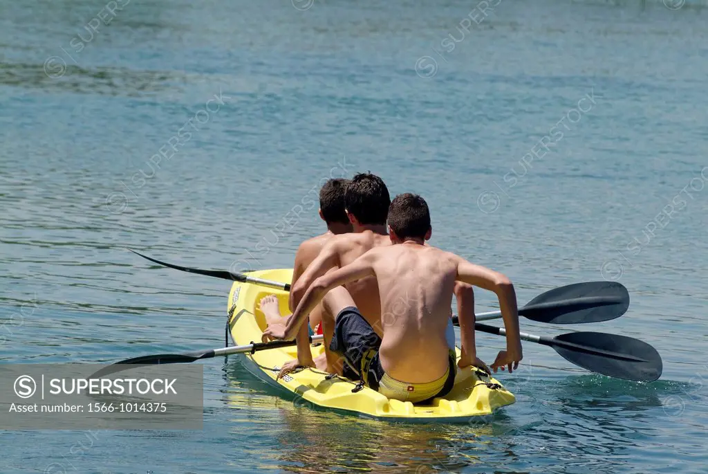 mates doing the kayak in the river Jucar, Carcaixent, Valencia, Spain