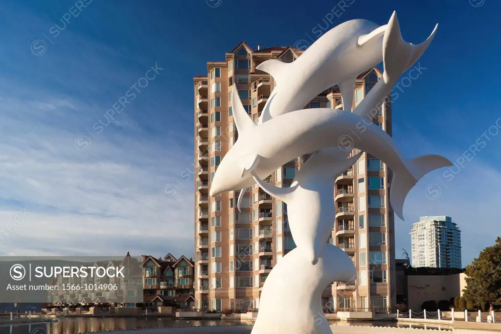 Canada, British Columbia, Okanagan Valley, Kelowna, condo building by Lake Okanagan and Dolphin Statue