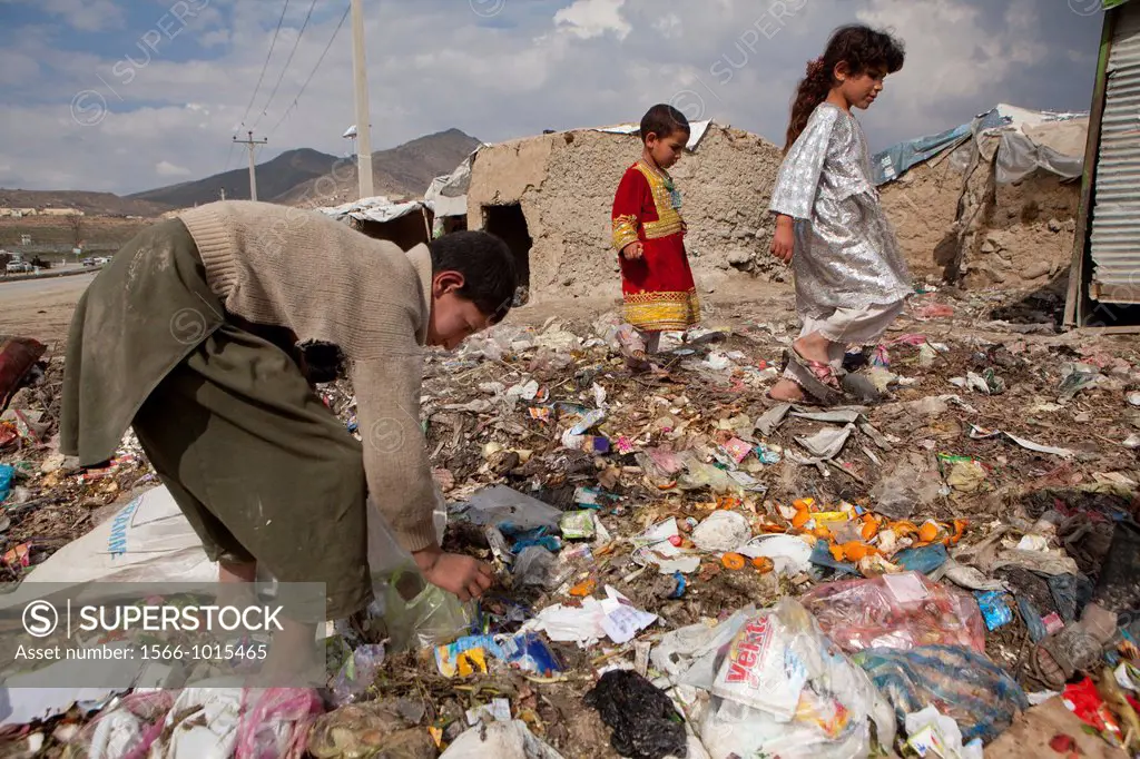 many children earn an income bt collecting plastic among rubbish, Kabul,