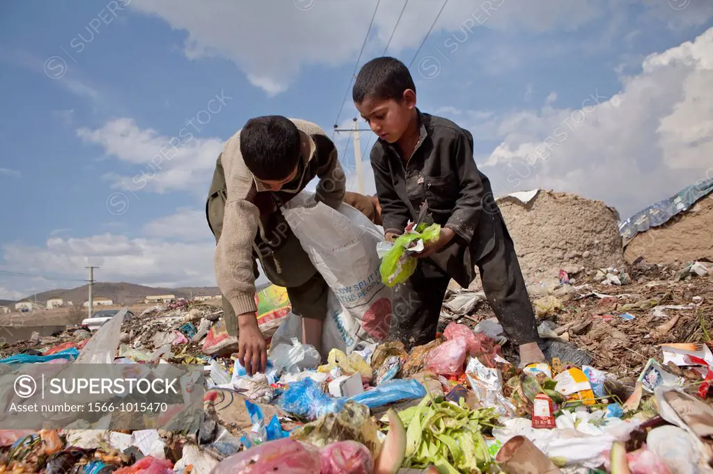 many children earn an income bt collecting plastic among rubbish, Kabul,