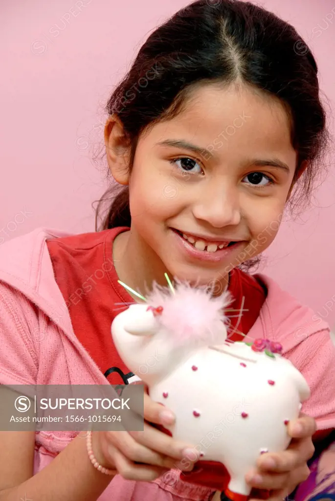 12 years old girl shaking a money box
