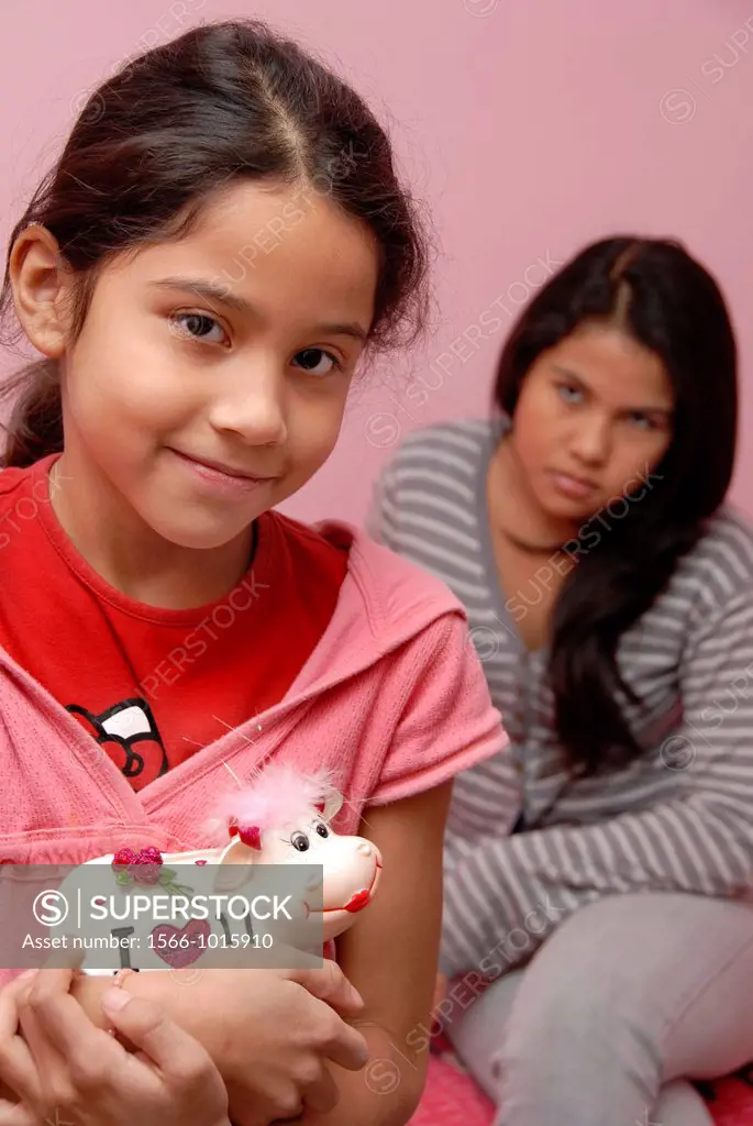 12 years old girl with her sister holding a money box