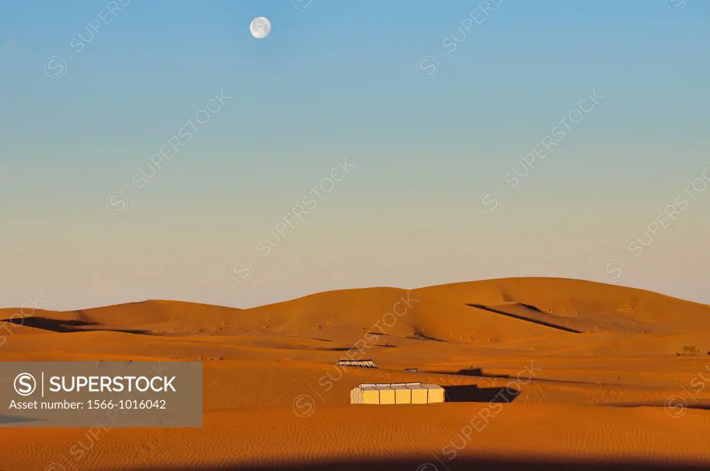 full moon over the Sahara Desert at Erg Chigaga, Morocco