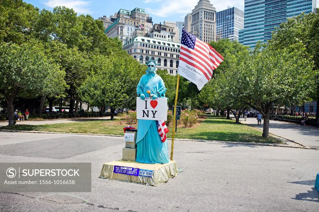 Mime mimics Statue of Liberty, Battery Park, Manhattan, New York City, USA.
