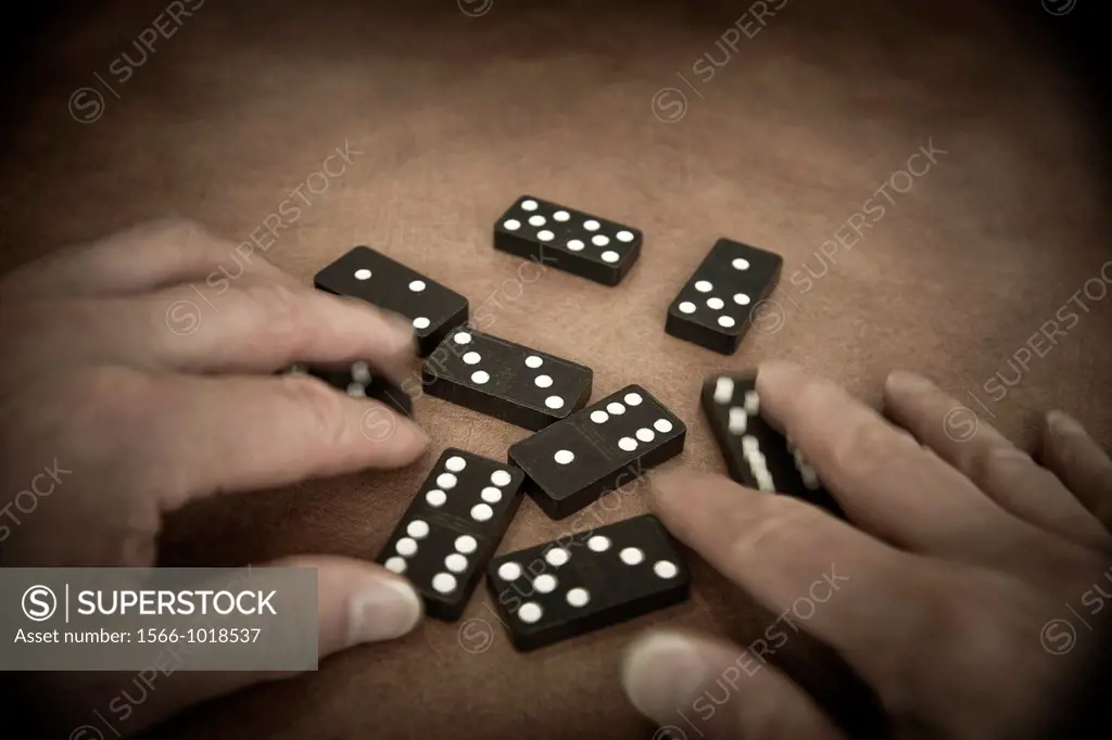 Man´s hands playing with dominoes