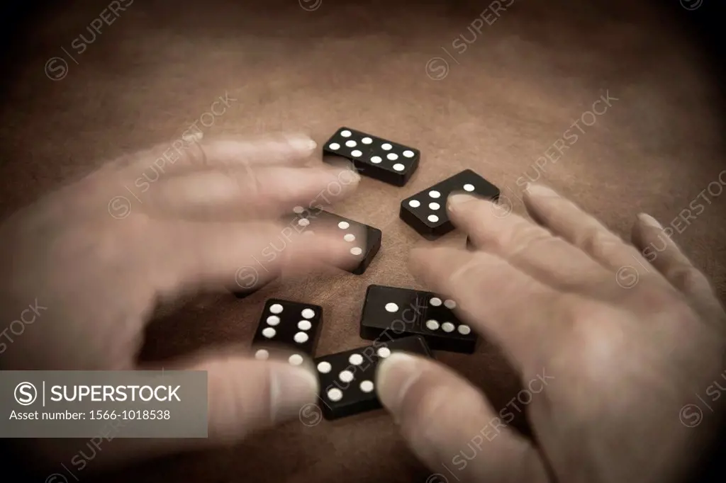Man´s hands playing with dominoes