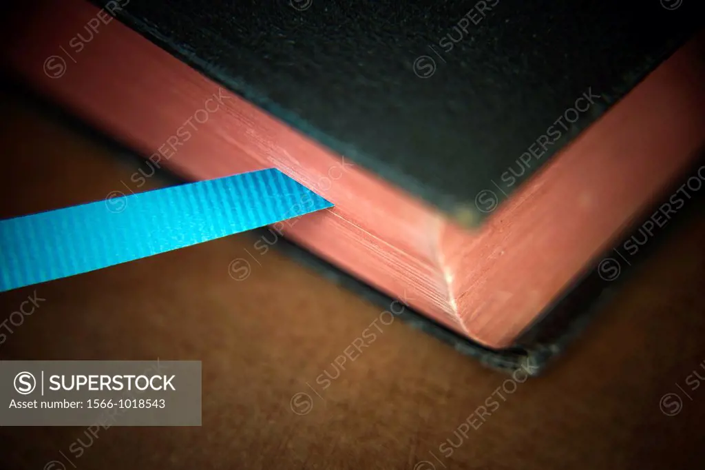 Close-up of an old book with a ribbon as a bookmark