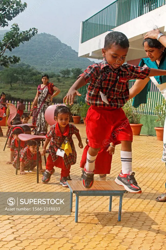 children playing in schoolyard, aaryan school, pune, maharashtra, india