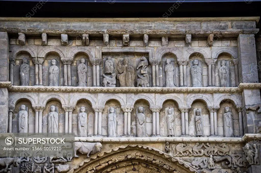 Christ in Majesty, flanked by symbols of Evangelistas, and by Apostoles. Detail of main portal of Romanesque Church Santa María la Real in medieval to...