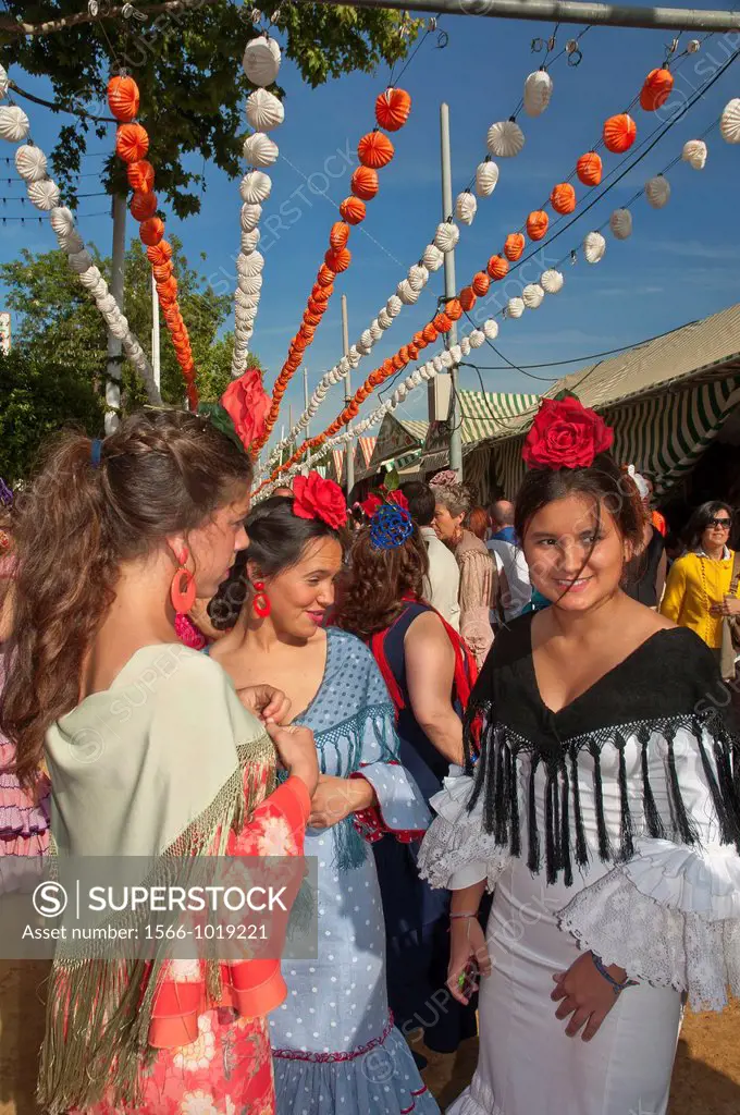 April Fair, Youngs women wearing a traditional flamenca dress, Seville, Spain        
