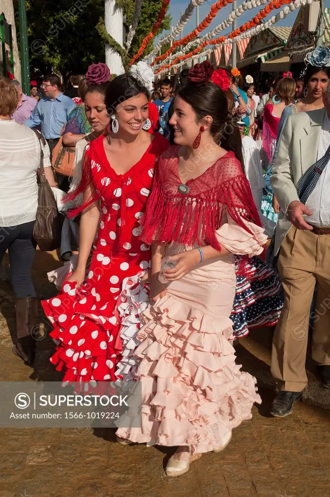 April Fair, Youngs women wearing a traditional flamenca dress, Seville, Spain