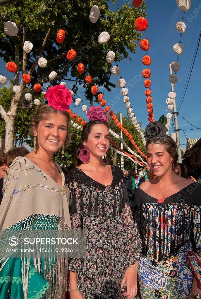 April Fair, Youngs women wearing a traditional flamenca dress, Seville, Spain        