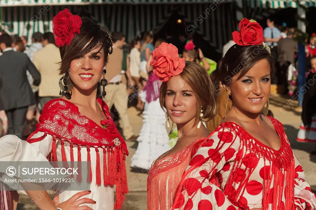 April Fair, Young women wearing a traditional flamenca dress, Seville, Spain