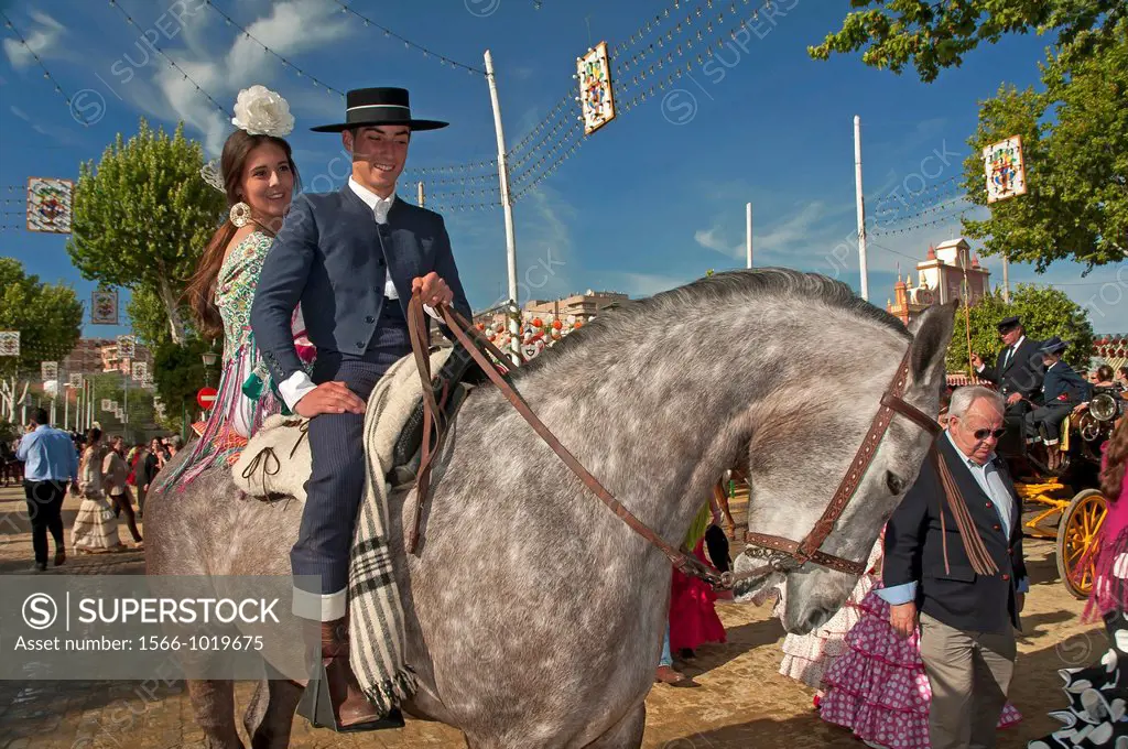 April Fair, Couple in traditional costumes on a horse, Seville, Spain        