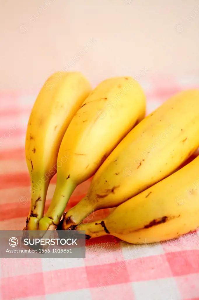 Bananas on red gingham cloth