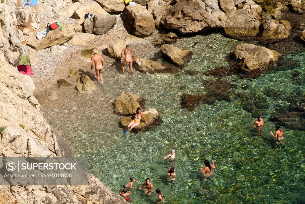 Basking in naturist beach, Les Rotes, Denia, Cape San Antonio, province of Alicante, Spain, Europe