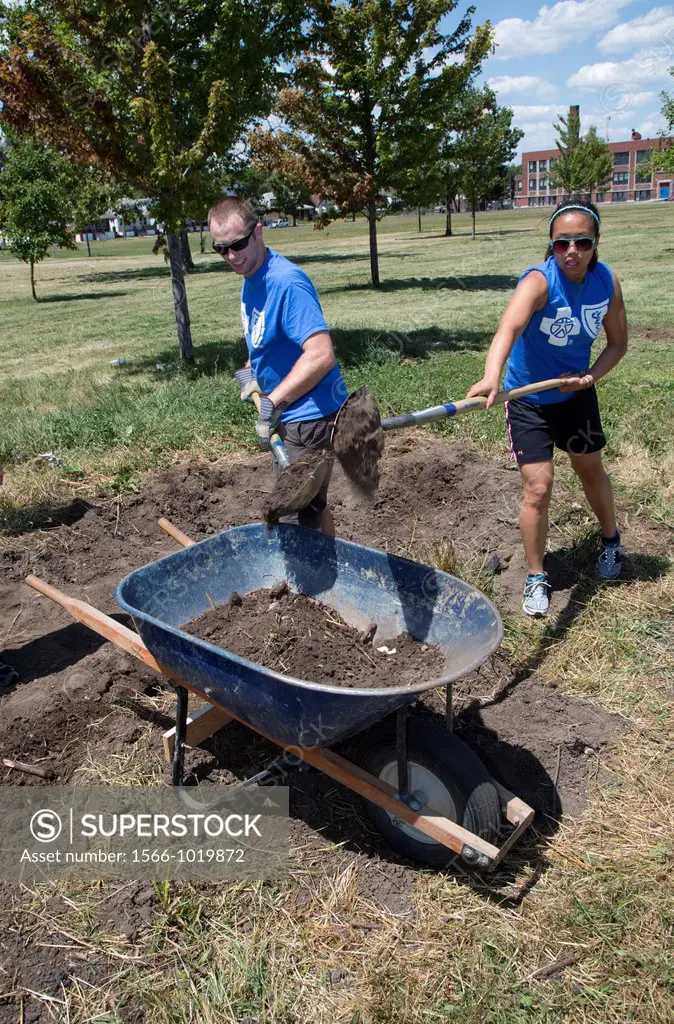 Detroit, Michigan - Interns from Blue Cross Blue Shield of Michigan work as volunteers in Romanowski Park, helping to create a community garden