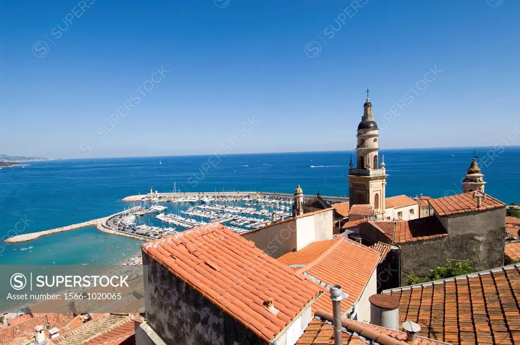 Menton, South of France, Basilica of St Michel above the rooftops in the Old Town, Port and one of the beaches below