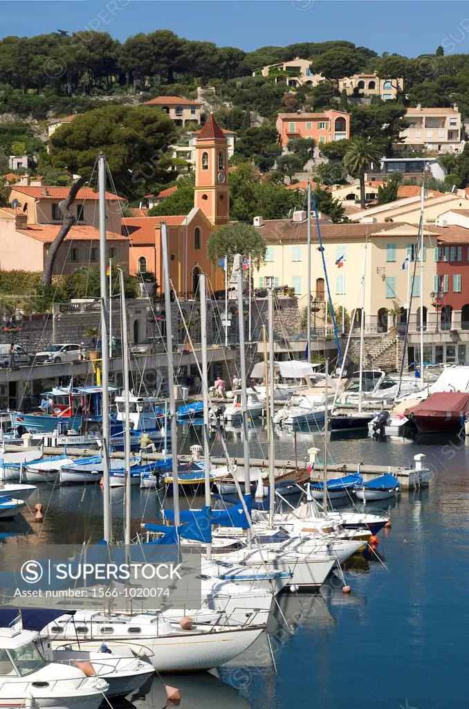 St Jean Cap Ferrat, South of France, The village of St  Jean with church, Harbour in foreground with fishing boats and yachts