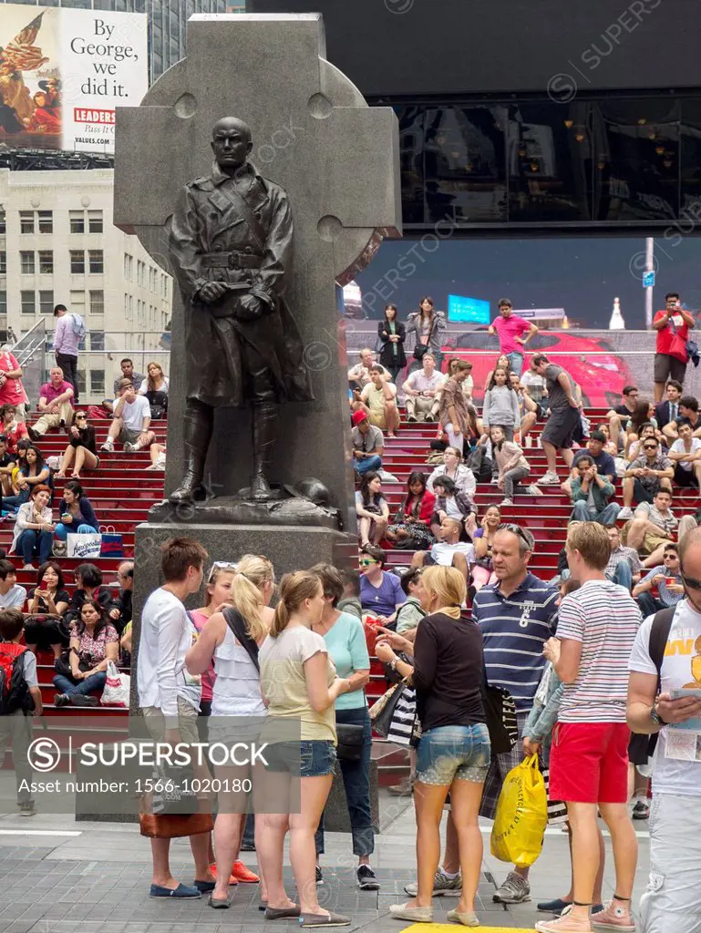 Tourists gather in Duffy Square, the upper part of Times Square, New York City  Note statue of Father Francis Duffy, chaplain of the famous Fighting 6...