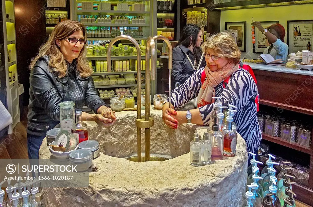 At an imported French soap shop in midtown Manhattan, New York City, women customers try out the products at an ornate stone sink