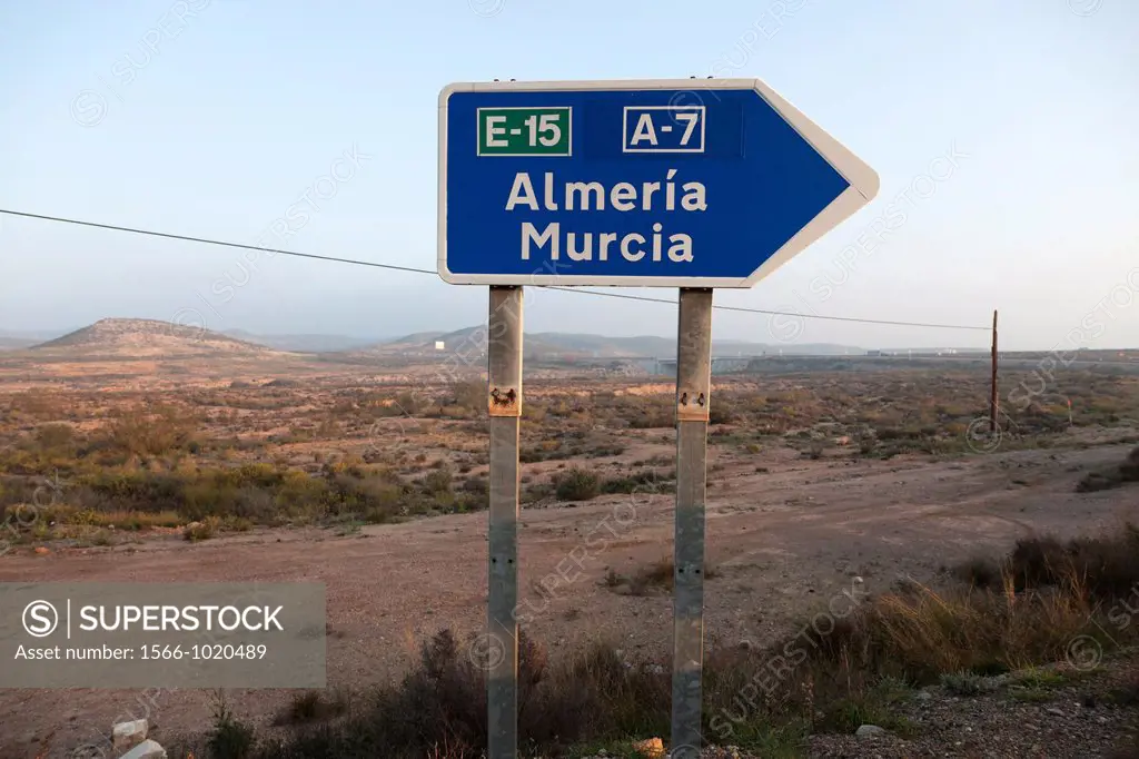 Desert landscape with blue road sign pointing provinces of Andalusia, Almeria, Murcia, Andalucia, Spain, Europe